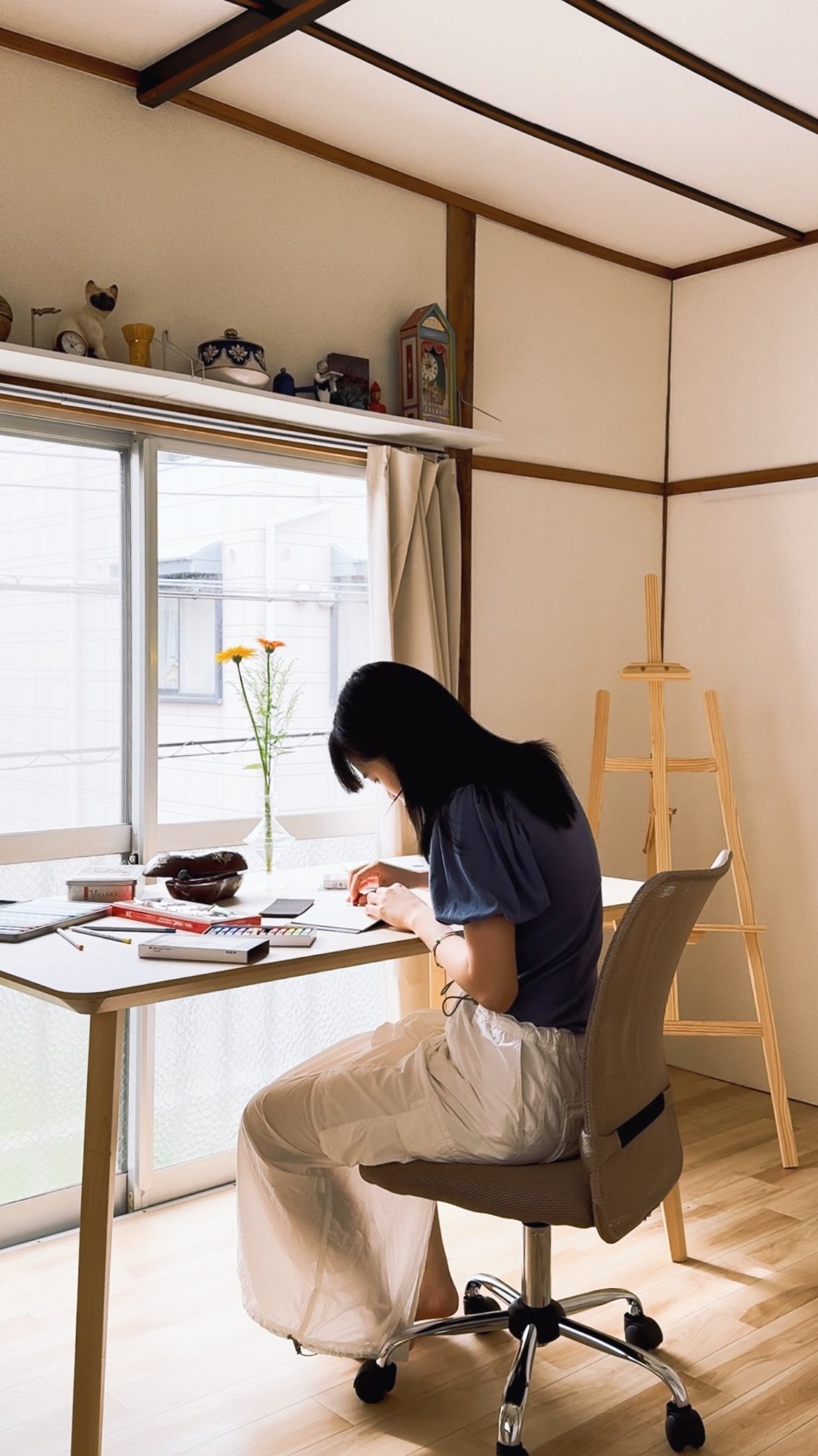 Drawing at the large worktable by the studio window